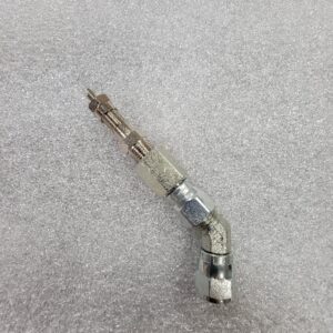 A metal automotive or machinery component on a gray surface.