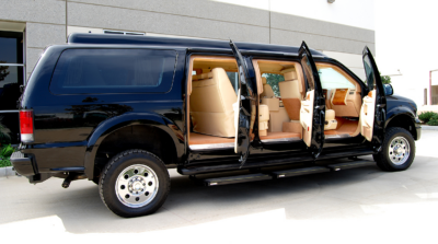 Black van with sliding doors a open showing beige interior seats.