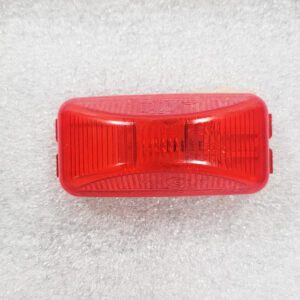 A red rectangular rear bicycle reflector on a white background.