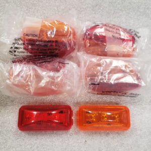 Various red and orange vehicle tail light covers wrapped in plastic.